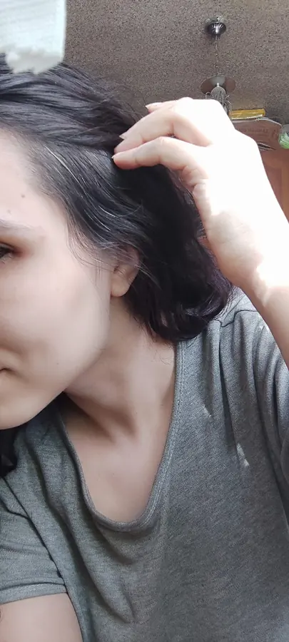 A selfie, half a face in the frame, a hand in the hair.